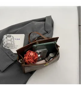 Detail view of large tote interior holding tablet, umbrella, and daily essentials