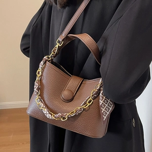 Retro brown lychee pattern handbag with silk scarf and chain strap shown on a model