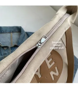 Close-up of premium silver metal zipper and smooth gliding hardware on nylon tote bag