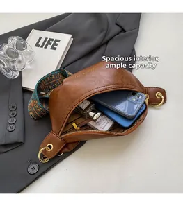 Detailed interior of brown faux leather waist bag with printed bohemian wide strap