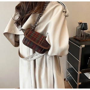 Classic checkered wool shoulder bag with metal chain strap shown in a lifestyle setting