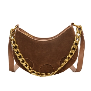Retro brown suede crescent saddle bag with bold gold chain handle and leather strap