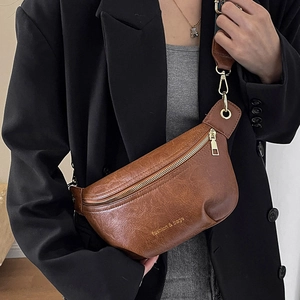 Brown leather crossbody chest bag for women with wide strap and golden fashion text