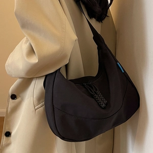 Large black nylon crescent hobo bag with woven zipper pull and blue detail tag