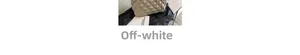 Detail of creamy white quilted tote bag featuring classic diamond stitch on dark fabric