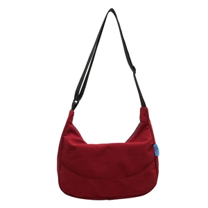Minimalist dark red nylon crescent crossbody bag with adjustable black shoulder strap