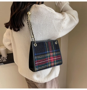 Dettaglio della borsa in tweed a quadri colorati con catena d'oro e fibbia a sfera