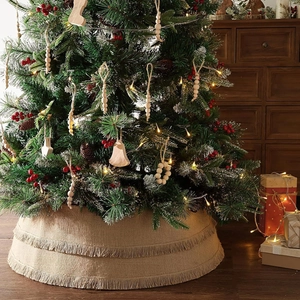 Detail of natural burlap Christmas tree skirt with double-layer tassels and knit texture