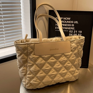 Chic beige quilted tote bag with large capacity and elegant leather shoulder straps