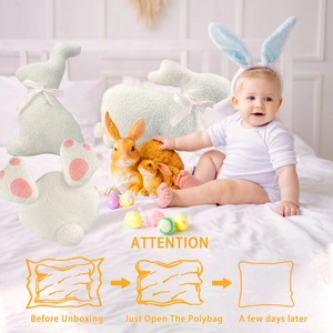 Detail of three white plush bunny pillows with pink bows for Easter home decoration