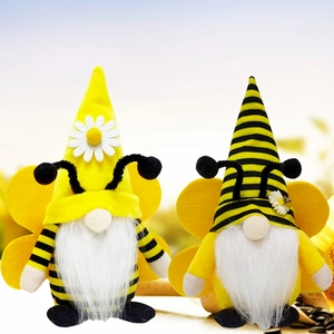 Macro shot of bee gnome plushies with stripes, gauzy wings, and tiny daisy flower details