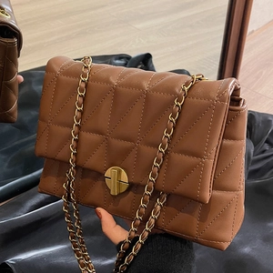 Brown quilted leather shoulder bag with triangle patterns and golden chain strap