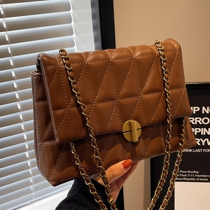 Deep brown quilted leather chain bag with gold hardware and elegant turn-lock closure