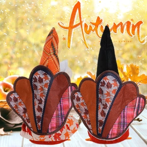 Close-up of autumn turkey gnomes with maple leaf tails and plaid hats on a cozy window