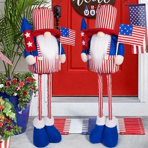 Detail of two patriotic gnomes with long legs and US flag outfits in front of a red door