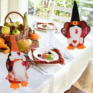Detail of plush Thanksgiving gnomes with autumn patterns on a cozy festive table