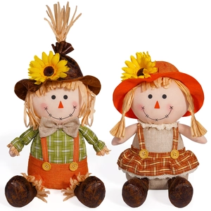Pair of autumn scarecrow dolls with sunflowers for harvest festival decorations