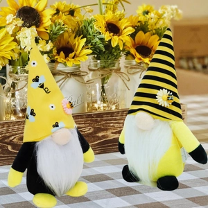 Detail of bee festival gnomes with sunflower decorations and long white fiber beards