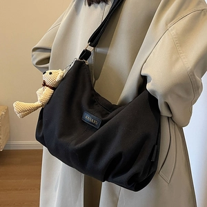 Black nylon hobo bag with large capacity and cute bear charm for daily commute