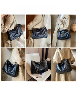 Detailed view of black quilted chain bag with gold hardware shown on a beige coat model