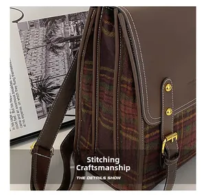 Detailed side view of vintage plaid backpack with premium stitching craft and leather layers