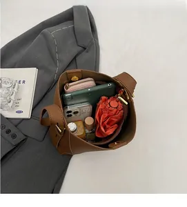 Interior view showing large capacity of the brown leather tote bag with daily items