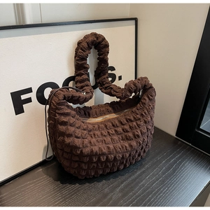 Detailed view of dark brown bubble texture nylon bag with scrunchie shoulder strap