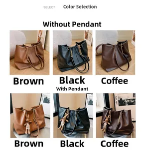 Detail view of large tote bags in brown, black and coffee with metallic chain accents