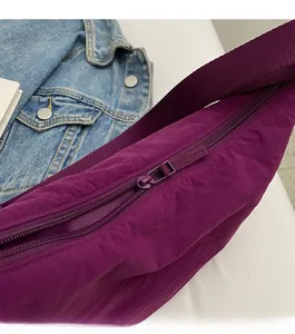 Detail of a smooth purple nylon bag zipper with natural folds and durable texture
