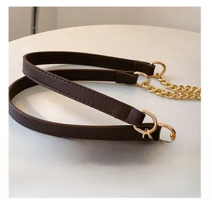 Close-up of brown PU leather shoulder strap with gold chain links and stitching detail