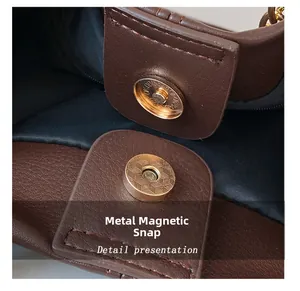 Macro detail of high-quality gold magnetic buckle on dark brown leather tote bag