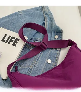 Detail of adjustable purple nylon shoulder strap and textured fabric with water resistance