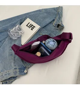 Interior view of purple nylon crescent bag showing large capacity and zipper pocket