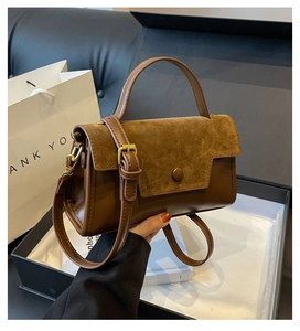 Close-up of dark brown vintage handbag with leather texture in a gift box packaging