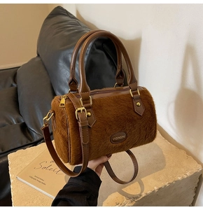Gros plan du sac peluche marron avec texture fausse fourrure et détails dorés
