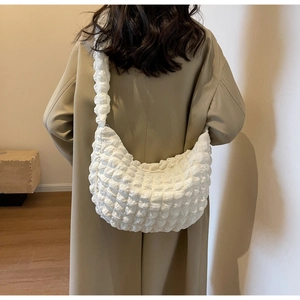 Close-up of white bubble texture nylon fabric on a high-capacity croissant shoulder bag