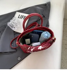 Top view of red patent leather handbag showing spacious interior for daily items
