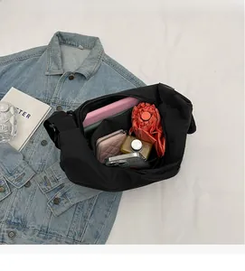 Interior view of large nylon crossbody bag showing ample space for daily essentials
