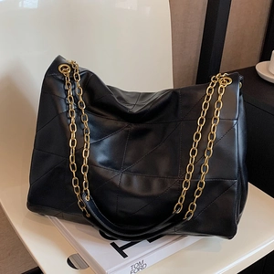Large black quilted leather tote bag with elegant gold chain straps for classic style
