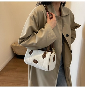 Modèle avec sac Boston en fausse fourrure blanche et détails en cuir marron chic