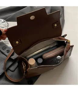 Detail view of the spacious interior of this vintage brown leather crossbody bag