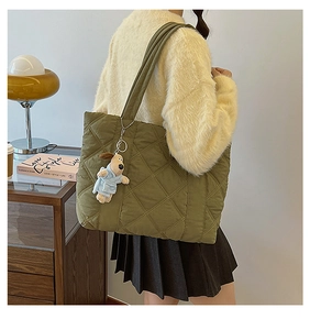 Army green quilted nylon tote bag with rhombus stitching and a cute dog plush pendant