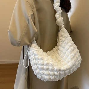 White nylon waffle texture crescent bag with pleated shoulder strap on model