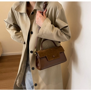 Detail of vintage brown shoulder bag with mixed faux suede and leather textures