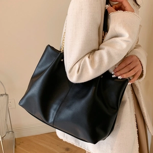 Large capacity black tote bag with gold chain detail and matte pebble grain texture