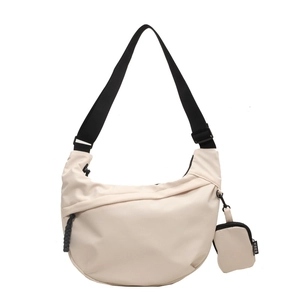 Beige nylon half-moon crossbody bag with adjustable wide strap and small coin purse charm