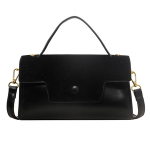 Classic black crossbody bag with matte and suede paneling and gold hardware accents