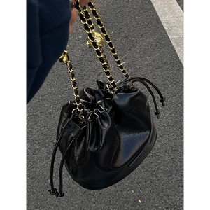Retro black faux leather bucket bag with gold chain strap and drawstring closure