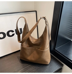 Dettaglio della borsa a secchiello hobo vintage marrone con trama martellata e tracolla