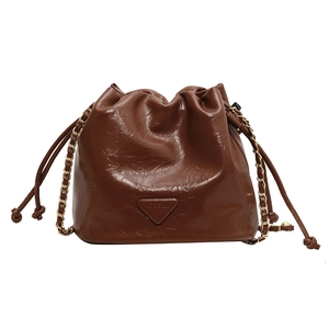 Brown vintage pleated bucket bag with gold chain strap and drawstring closure for women